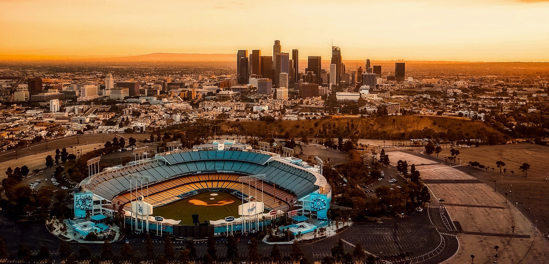Dodger Stadium at sunset over the Los Angeles skyline