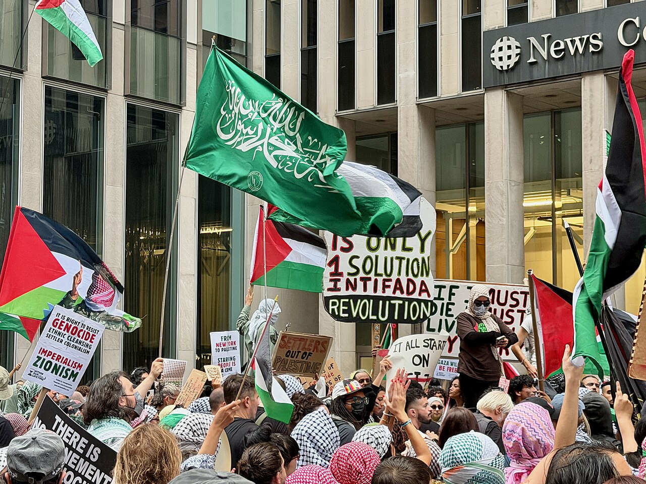 Pro-Palestinian demonstrators with flags and signs at a rally in New York City on the Oct. 7 anniversary.