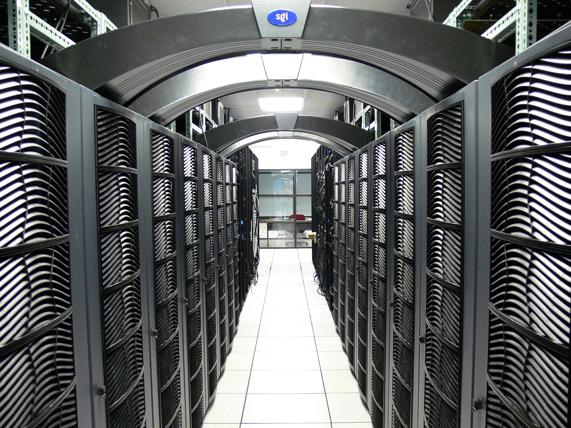Rows of compute racks in a bright data center corridor