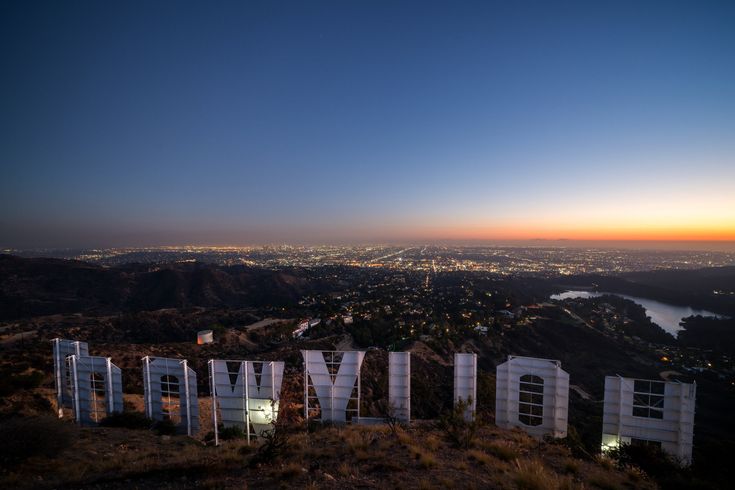 The Hollywood sign at dusk overlooking the Los Angeles city lights