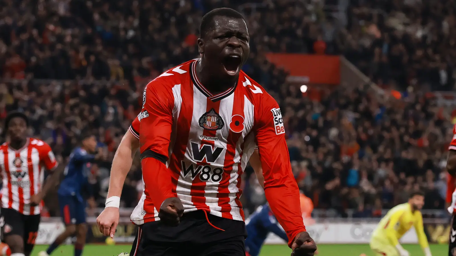 Sunderland striker Brian Brobbey celebrates a goal in the red-and-white stripes.