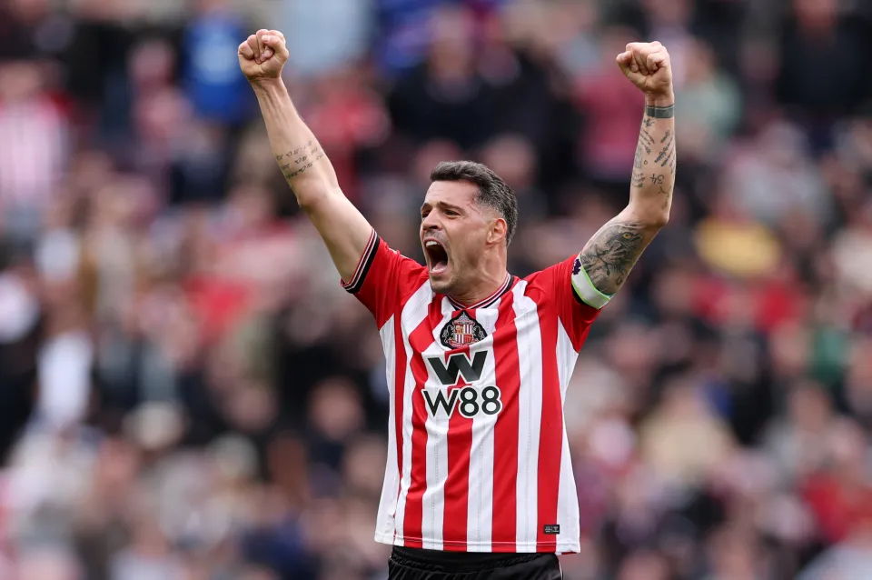 Sunderland captain Granit Xhaka celebrates a victory with the armband on, fists raised.