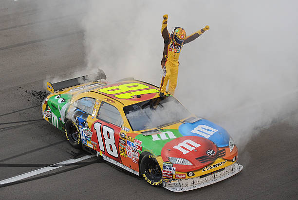 Kyle Busch celebrates a victory in the No. 18 M&M's car with a burnout