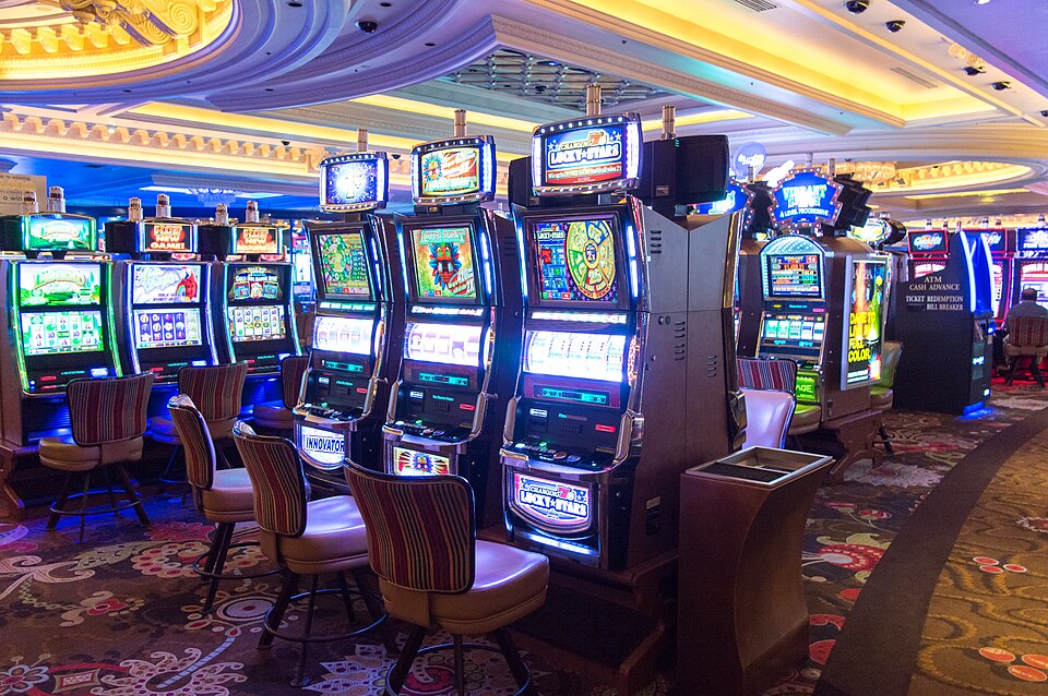 Modern video slot machines with glowing screens on a casino floor