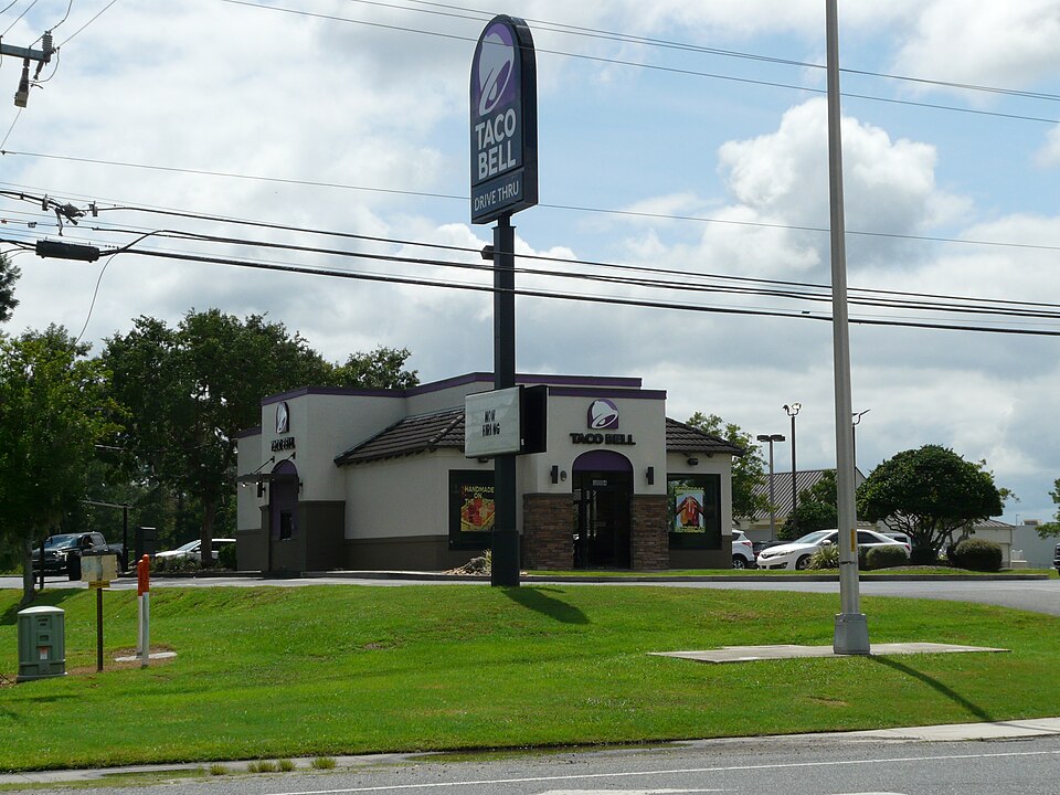A Taco Bell restaurant in daylight, the kind of storefront the chain is now reimagining as its beverage-first Live Más Café concept