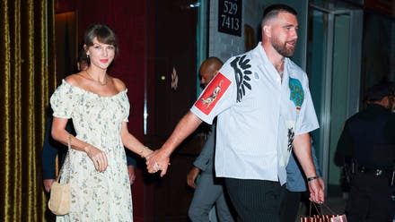 Taylor Swift and Travis Kelce holding hands as they leave a venue in New York