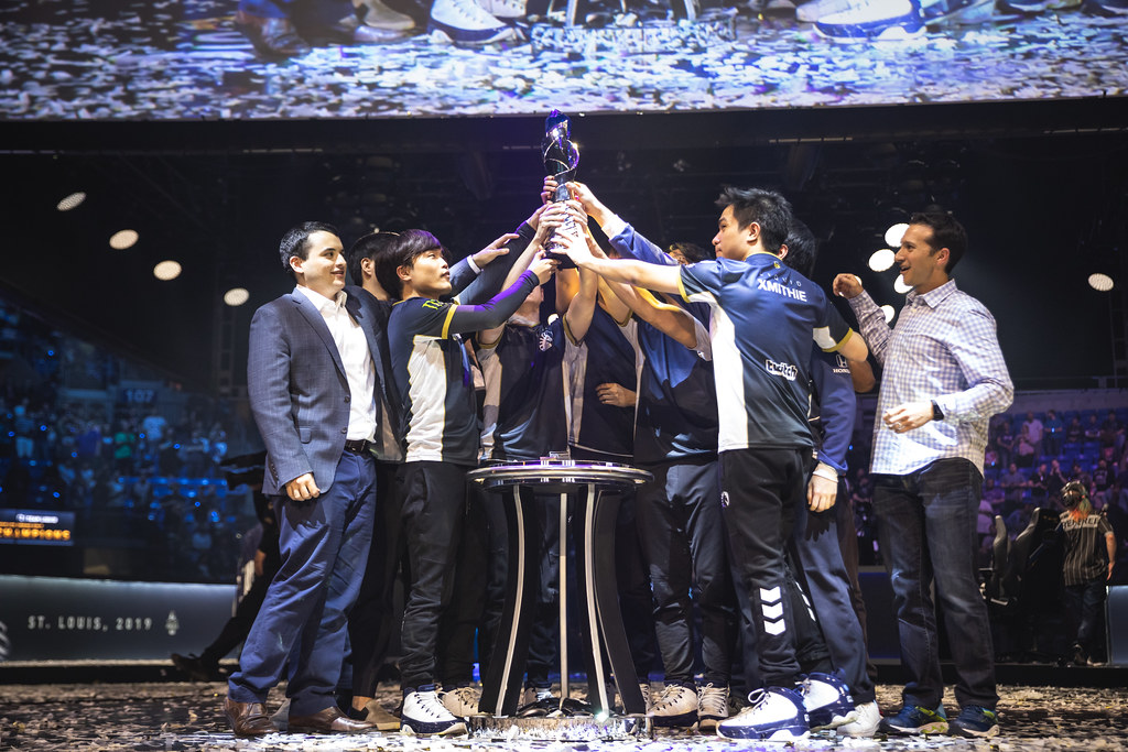 Team Liquid players celebrating with the LCS championship trophy on stage