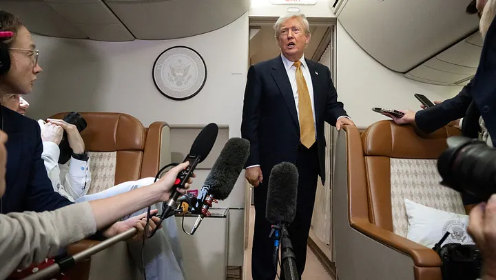President Trump speaking with reporters aboard Air Force One