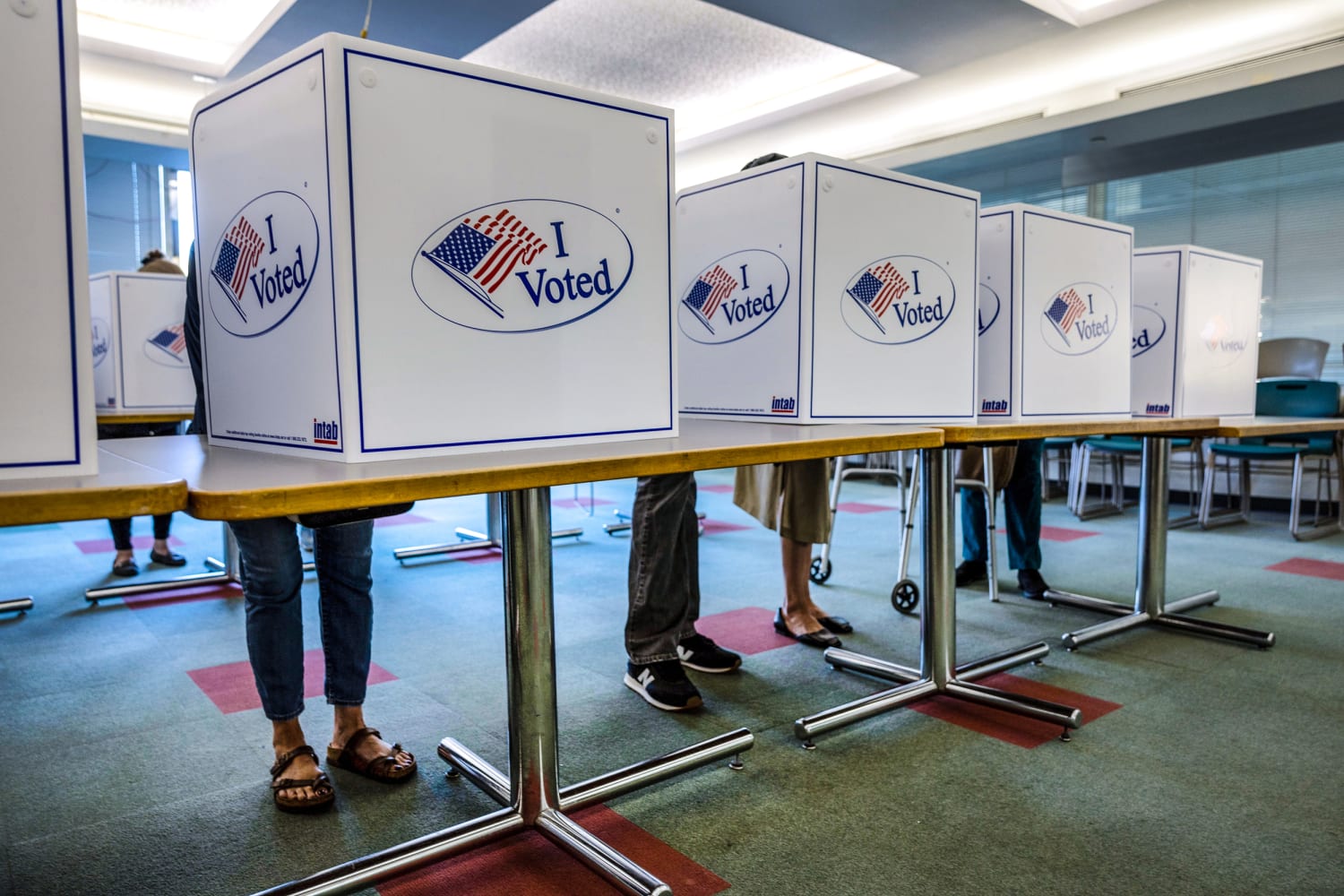Voting booths with I Voted stickers at a polling place