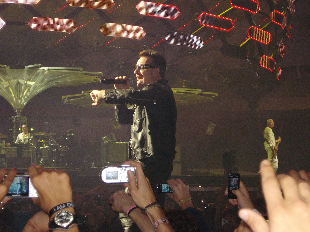 Bono performing with U2 in concert