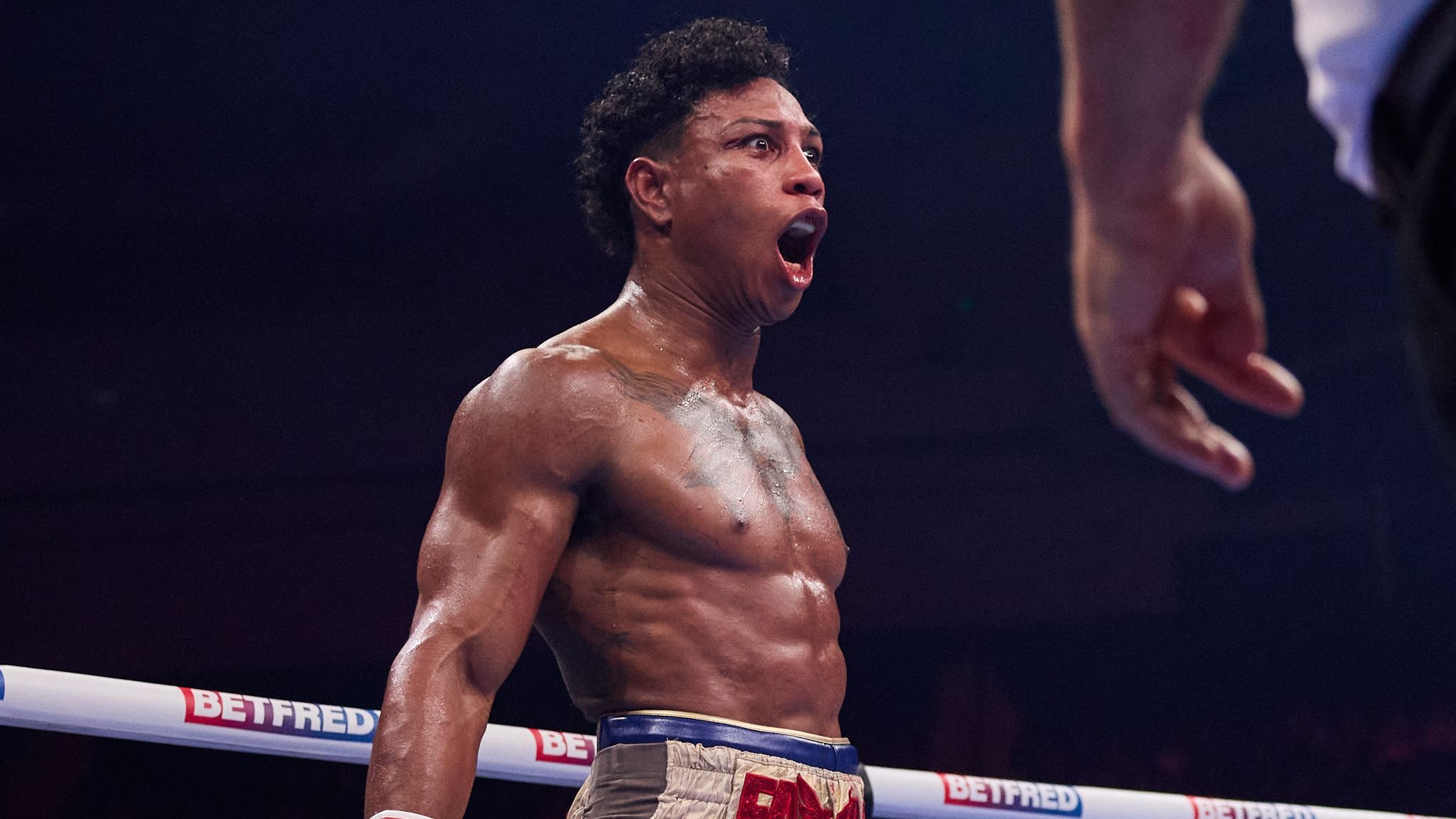 Bilal Fawaz celebrates in the ring after defending his British title