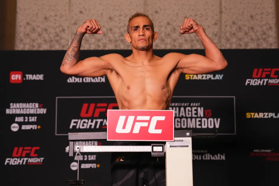 A UFC fighter flexes on the official weigh-in scale at a UFC Fight Night event