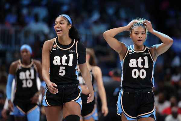 Las Vegas Aces star A'ja Wilson celebrating in the white home uniform.