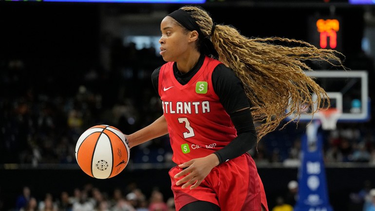 Atlanta Dream guard Jordin Canada handling the ball during a game.