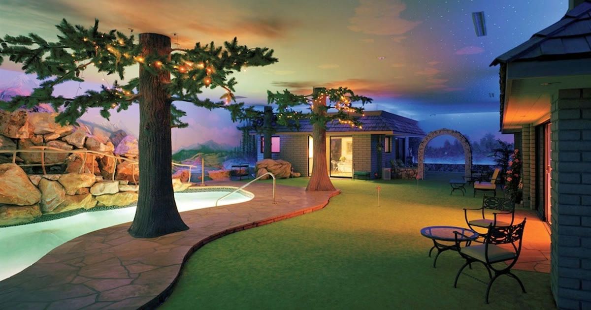 1970s living room with hand-painted mural inside the underground bunker home